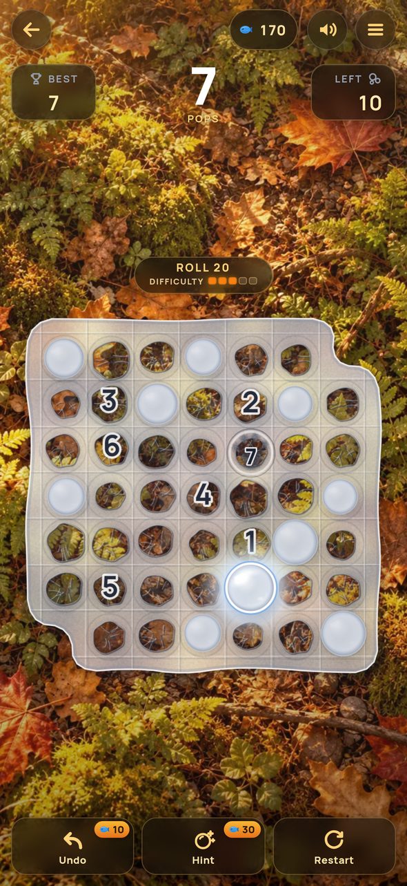 A roll in play: an irregular sheet of bubble wrap on a forest floor, seven bubbles popped and numbered in order, with Undo, Hint and Restart below.